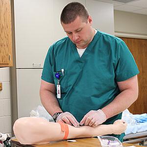 Image of student practicing blood draw